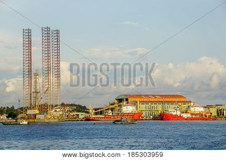 Labuan,Malaysia-June 17,2016:Multi function offshore support/platform supply vessels & Jackup oil rig platform under repair at shipyard in Labuan,Malaysia on 17th June 2016.