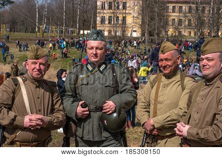 Gatchina Russia - May 7 2017: Historical reconstruction of the battles of World War II. German and Soviet soldiers after the battle - photographing for memory.
