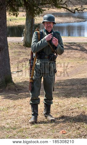 Gatchina, Russia - May 7, 2017: Historical reconstruction of the battles of World War II. A participant in the reconstruction in the form of a Wehrmacht soldier before the start of the battle.