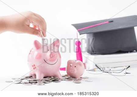 Child Hand Put Notebank In A Piggybank,