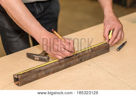 Man Working And Use A Pencil And Tape Measure