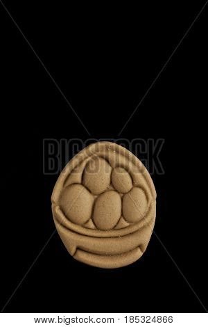 Dog biscuit on black background to connote a concept of feeding animals