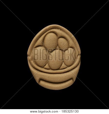 Dog biscuit on black background to connote a concept of feeding animals