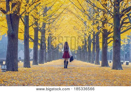 Beautiful Girl With Yellow Leaves In Nami Island, Korea. Vintage Tone Style.