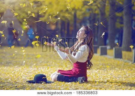 Beautiful Girl With Yellow Leaves In Nami Island, Korea. Nami Island In Autumn. Vintage Tone Style.(