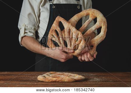 baker is holding fougas bread