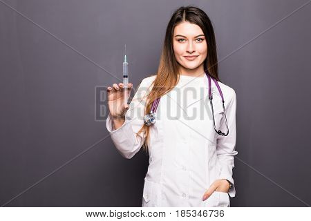 Young Doctor Woman With Syringe On Grey Background