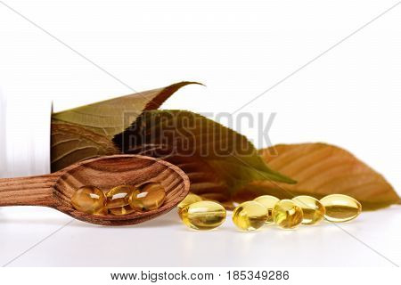 Fish Oil Omega 3 Gel Capsules In Spoon With Leaves