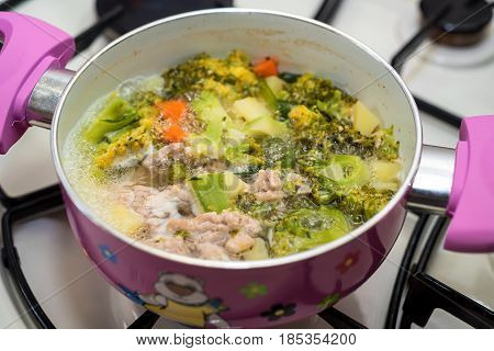 Close-up of preparing healthy dietic soup on gas stove