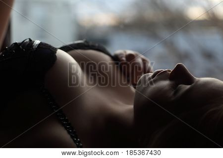 Young Sexy Woman Lying Near Window. Provocative And Sensuality. Closeup Portrait. Hot Girl In Linger