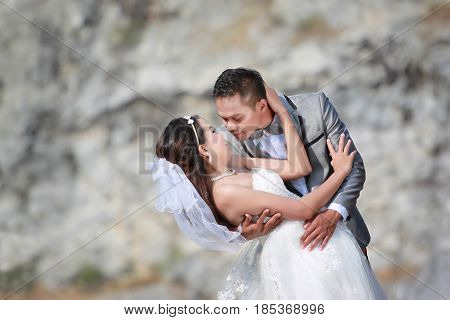 Asian couples photos of pre wedding concept of love and Marriage in nature outdoor on rocky mountain background.