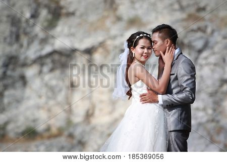 Asian couples photos of pre wedding concept of love and Marriage in nature outdoor on rocky mountain background.