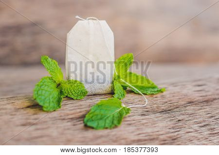 Tea Bags On Wooden Background With Fresh Melissa, Mint. Tea With Mint Concept