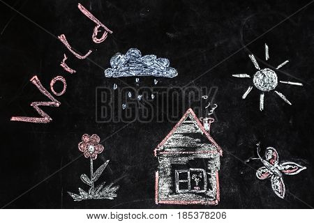 children's chalk drawing of house and sun on black background the concept of nature and the environment
