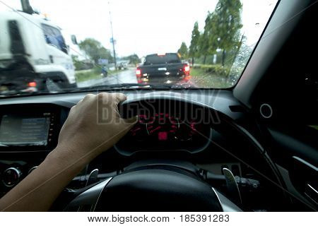 Driving car raining time on the road.