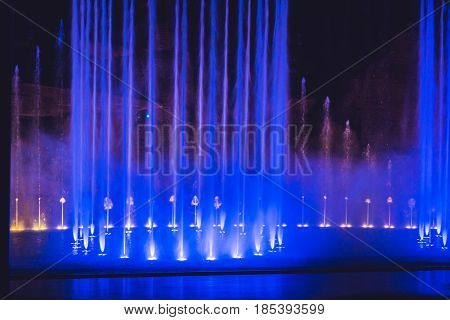 Multicolored Dancing Water Jet Fountain In The Dark