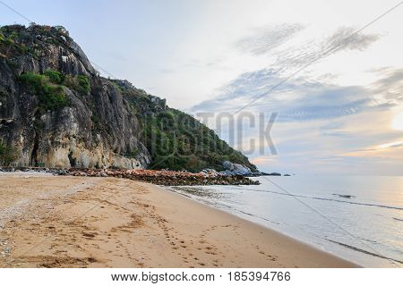 Soft wave of sea on sandy beach with sunlight in morning