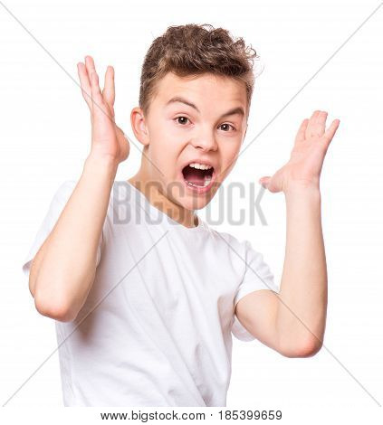 Emotional portrait of amazed or surprised teen boy in white t-shirt. Funny cute cheerful child screaming with wide open mouth, isolated on white background.