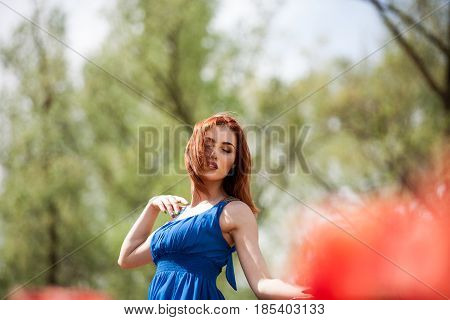 Dreammy woman in outdoor photo in sunny summer day. Beautiful girl in springtime