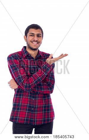 Portrait of a happy smiley friendly young man standing confidently and showing something guy wearing red caro shirt and jeans isolated on white background