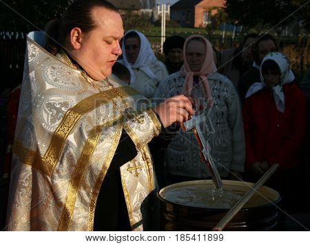 VOYUTYN UKRAINE - 14 OCTOBER 2008: Orthodox priest blessing of water during the religious celebration Pokrov