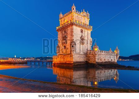 Belem Tower or Tower of St Vincent on the bank of the Tagus River during evening blue hour, Lisbon, Portugal