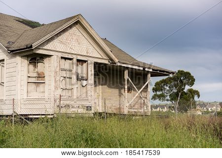 Single bungalow or family home abandoned and overgrown and in need of renovation or loving tender care