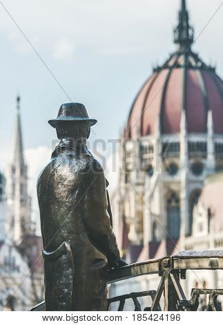 Bronze monument of Hungarian national hero Imre Nagy standing on bridge and looking towards Hungarian Parliament building in Budapest, Hungary on clear sunny day