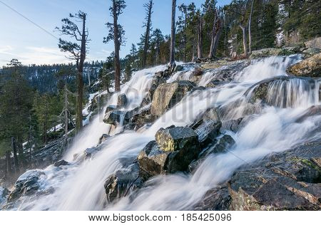 Sunrise at Emerald Bay on Lake Tahoe from the top of Lower Eagle Falls. Torrent of water from snow melt flows into the lake from Sierra Nevada Mountains