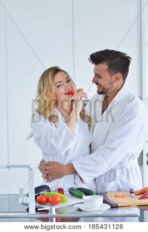 Happy couple cooking breakfast together in the kitchen.