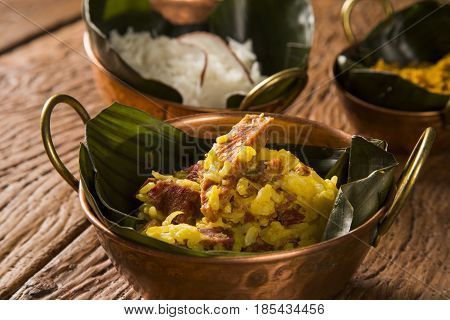 Rice With Coconut, Yellow Flour And  Dried Meat With Rice In An Old Copper Pot - Traditional Bahia F