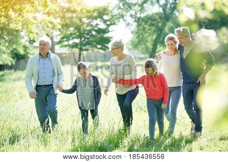 Happy family of 6 walking in park