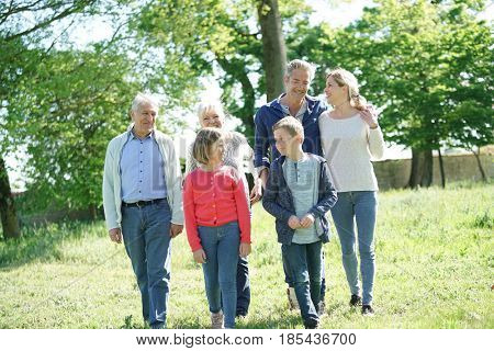 Happy intergenerational family walking in garden
