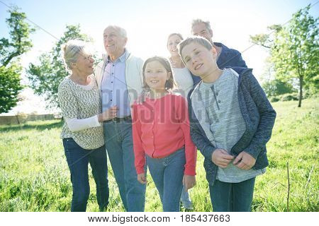 Happy intergenerational family walking in park