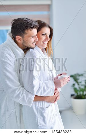 Young goodlooking couple posing in their kitchen.