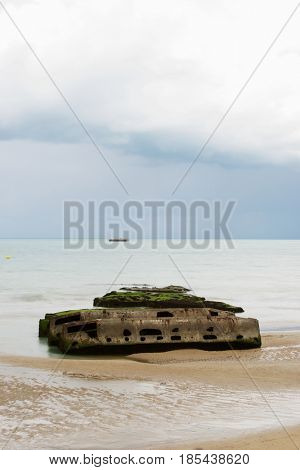 Ruins of harbor built by the Allies in Arromanches, Normandy, France.