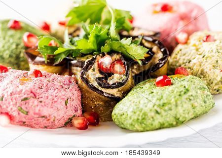 Spinach appetizer phali with pomegranate seeds close up. Georgian cuisine.
