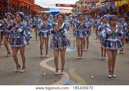 ORURO, BOLIVIA - FEBRUARY 26, 2017: Caporales dancers in ornate costumes performing as they parade through the mining city of Oruro on the Altiplano of Bolivia during the annual carnival.