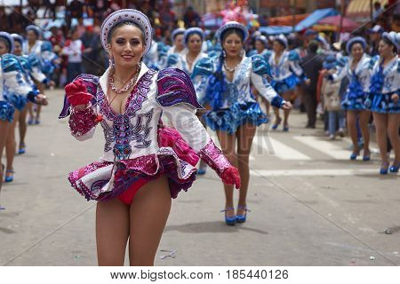 ORURO, BOLIVIA - FEBRUARY 26, 2017: Caporales dancers in ornate costumes performing as they parade through the mining city of Oruro on the Altiplano of Bolivia during the annual carnival.