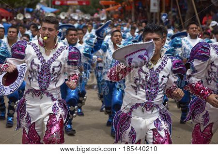 ORURO, BOLIVIA - FEBRUARY 26, 2017: Caporales dancers in ornate costumes performing as they parade through the mining city of Oruro on the Altiplano of Bolivia during the annual carnival.