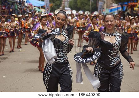 ORURO, BOLIVIA - FEBRUARY 26, 2017: Caporales dancers in ornate costumes performing as they parade through the mining city of Oruro on the Altiplano of Bolivia during the annual carnival.