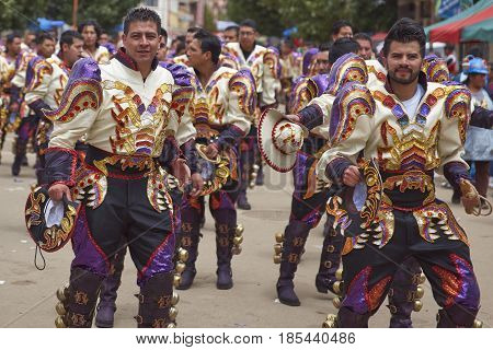 ORURO, BOLIVIA - FEBRUARY 26, 2017: Caporales dancers in ornate costumes performing as they parade through the mining city of Oruro on the Altiplano of Bolivia during the annual carnival.
