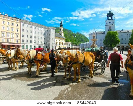 Central place in Salzburg city , Austria with carriages and horses