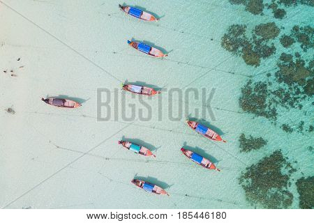 Aerial view over group of long tail boatsTop view from drone Koh Lipe island SatunThailand.