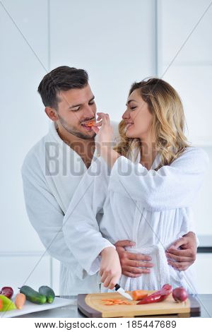 Happy couple cooking breakfast together in the kitchen.