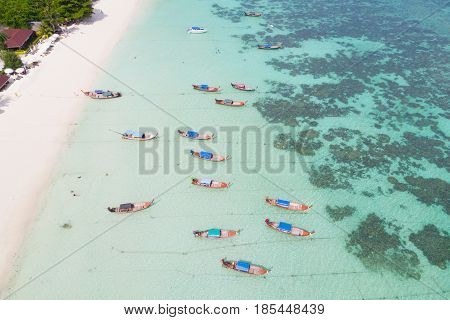 Aerial view over group of long tail boatsTop view from drone Koh Lipe island SatunThailand.