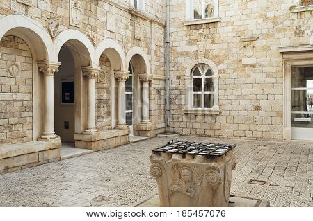Narrow street and charming facades in old town of Trogir