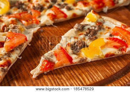 Junk food, bad habits. Pizza sliced on rustic wooden table background. Italian traditional meal