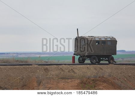 Construction Trailer on road construction work - industrial equipment among fields, telephoto