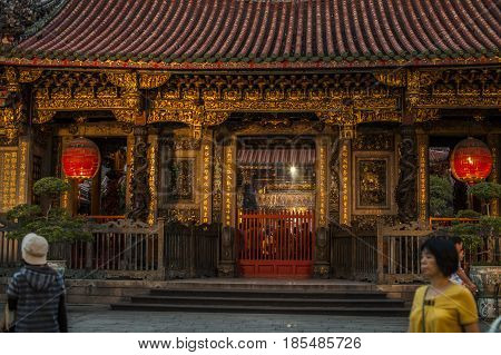 Taipei Taiwan - 6 October 2012: People praying and lighting incense at Longshan Temple in the center of the city